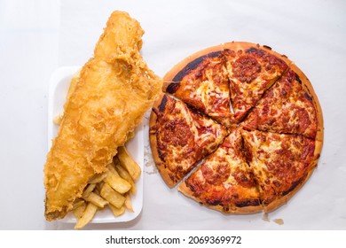 Pepperoni Pizza And Fish And Chips Cut Out On A White Background, From Above