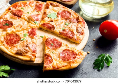 Pepperoni Pizza - Fresh Homemade Pizza With Pepperoni, Cheese And Tomato Sauce On Rustic Black Stone Background Wirh Copy Space.