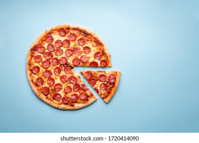 Pepperoni Pizza On A Blue Background Top View. Traditional Italian Food. Flatlay With A Home-baked Pizza With Hot Pepperoni And Mozzarella.