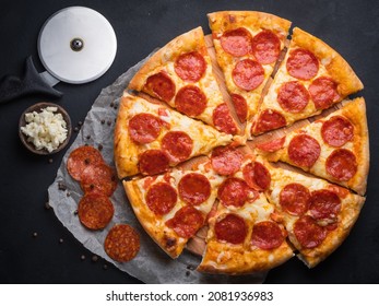 Pepperoni Pizza With Sausage On A Dark Background.