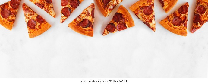Pepperoni Pizza Slice Top Border. Overhead View On A White Marble Banner Background. Copy Space.