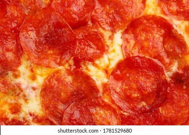 Pepperoni Pizza Texture Closeup With Basil Top View. Pizza Background