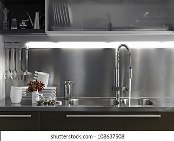 peppers and white dishes on the steel surface in the kitchen - Powered by Shutterstock