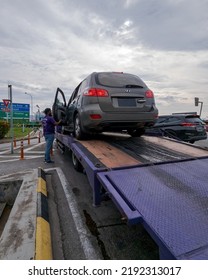 Perak, Malaysia - Aug 7, 2022 : Setting Up The Broken Car On The Truck For Transportation.