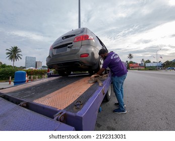 Perak, Malaysia - Aug 7, 2022 : Setting Up The Broken Car On The Truck For Transportation.