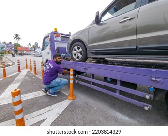 Perak, Malaysia - Aug 7, 2022 : Setting Up The Broken Car On The Truck For Transportation.