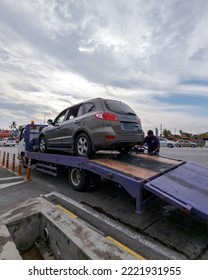 Perak, Malaysia - Aug 7, 2022 : Setting Up The Broken Car On The Truck For Transportation.