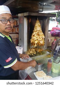 Perak, Malaysia. December 6,2018: Malay Hawker Preparing Kebab Burger At His Stall At Kg Koh Thursday Market.