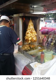 Perak, Malaysia. December 6,2018: Malay Hawker Preparing Kebab Burger At His Stall At Kg Koh Thursday Market.