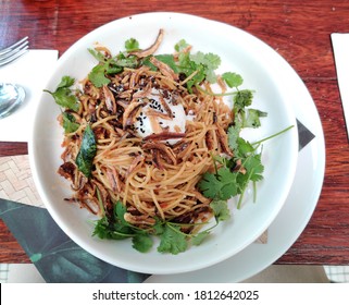 Perak, Malaysia - Sept 6, 2020: A View From Top Of A Fusion Dish Between Italian And Asian Which Has Pasta, Olive Oil, Mushrooms, Anchovies, Cilantro And Half-cooked Egg. Blurry Background