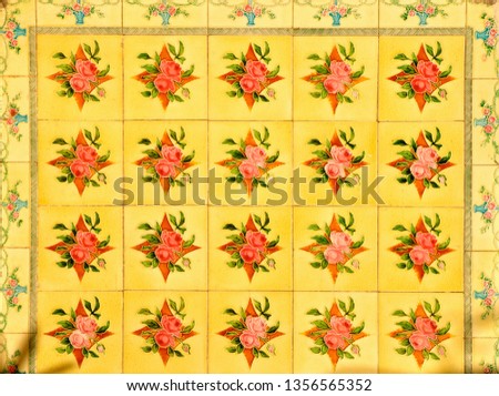 Peranakan tile mosaic of red flowers on a yellow background, typical facade found on traditional Chinese shop houses in China town, throughout South East Asia. 