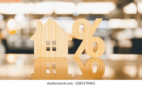Percentage and house sign symbol icon wooden on wood table. Concepts of home interest, real estate, investing in inflation.
 - Shutterstock ID 2285170463