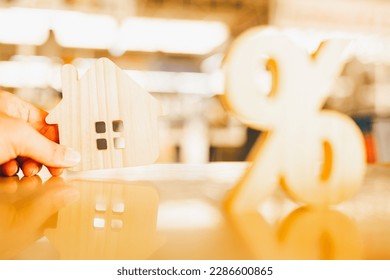 Percentage and house sign symbol icon wooden on wood table. Concepts of home interest, real estate, investing in inflation. - Shutterstock ID 2286600865