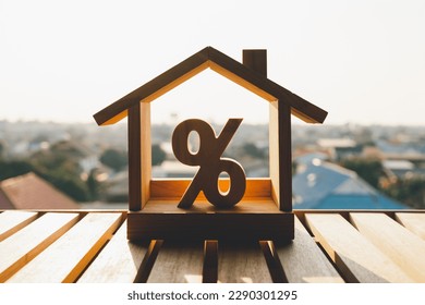 Percentage and house sign symbol icon wooden on wood table. Concepts of home interest, real estate, investing in inflation. - Shutterstock ID 2290301295