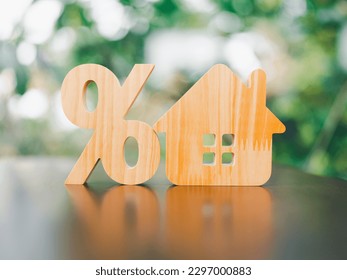 Percentage and house sign symbol icon wooden on wood table. Concepts of home interest, real estate, investing in inflation. - Shutterstock ID 2297000883