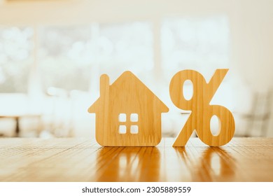 Percentage and house sign symbol icon wooden on wood table. Concepts of home interest, real estate, investing in inflation.	 - Shutterstock ID 2305889559
