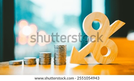 Percentage model, coin stack and down arrow, concepts for success, methods, systems of raising or lowering Fed interest rates to correct inflation concepts.