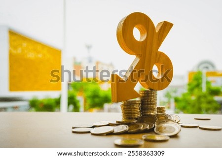 Percentage model, coin stack and down arrow, concepts for success, methods, systems of raising or lowering Fed interest rates to correct inflation concepts.