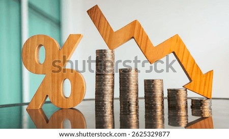Percentage model, coin stack and down arrow, concepts for success, methods, systems of raising or lowering Fed interest rates to correct inflation concepts.