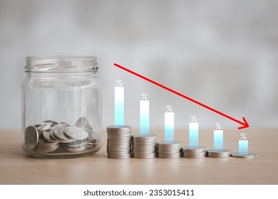 Percentage sign on the stack of coin bar chart and red graph trending downward with blur wall background on table. Economy recession crisis, inflation, stagflation, business and financial loss concept