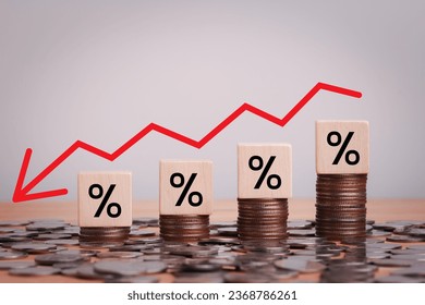 Percentage sign on wooden cubes with Stack of coin bar chart and red graph trending downwards on white background. Economy recession crisis, inflation, stagflation, business and financial loss concept