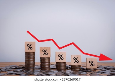 Percentage sign on wooden cubes with Stack of coin bar chart and red graph trending downwards on white background. Economy recession crisis, inflation, stagflation, business and financial loss concept - Powered by Shutterstock - Get 15% off with code: PIKWIZARD15