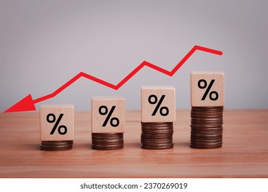 Percentage sign on wooden cubes with Stack of coin bar chart and red graph trending downwards on white background. Economy recession crisis, inflation, stagflation, business and financial loss concept