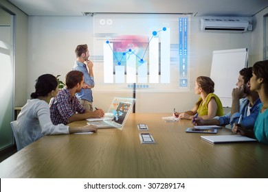 Percentages graphical representation against attentive business team following a presentation - Shutterstock ID 307289174