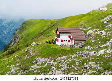 Perched atop a rocky outcrop, this solitary house in the mountains commands a breathtaking view of the rugged landscape that stretches as far as the eye can see - Powered by Shutterstock