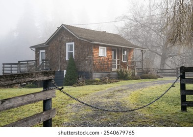 Perched on a gentle hill this cabin’s rustic charm is highlighted by the  wood shingles, which blend harmoniously with the natural landscape - Powered by Shutterstock