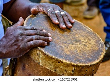 Percussionist playing a rudimentary atabaque during afro-brazilian cultural manifestation