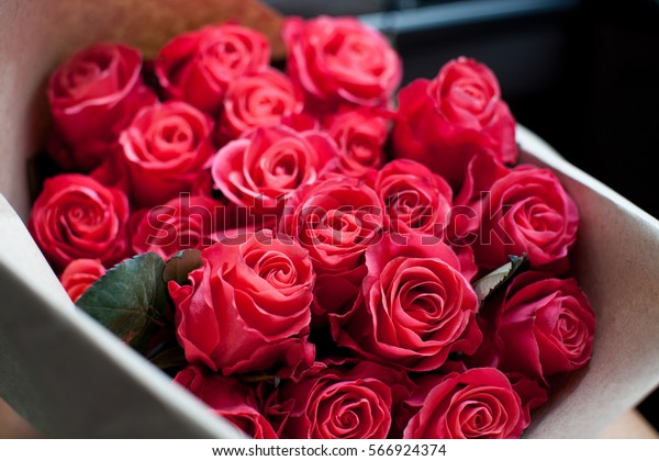 Perfect bouquet of fresh cut roses in car.\
Valentine day\
background.