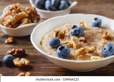 Perfect Breakfast. Oatmeal With Blueberries. Healthy Eating For The Whole Family. Wood Background.