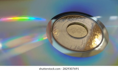 Perfect central ring of a compact disc casting subtle rainbow colors onto a grey silver floor. industrial minimalism, musical storage, tech object.