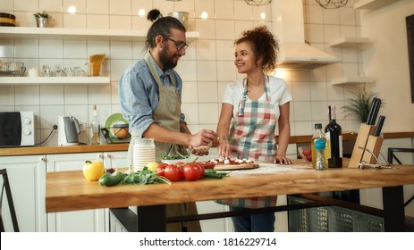 The Perfect Chef. Young Couple Making Pizza Together At Home. Man In Apron Adding Mozzarella Cheese On The Dough While Woman Looking At Him. Hobby, Lifestyle. Web Banner