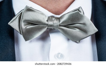 Perfect choice for your wedding party ensemble. Silver colored bowtie with white shirt. Bowtie collection. Fashion accessory. Formal style. Festive occasion. Holiday celebration