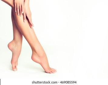 Perfect clean female feet . Beautiful and elegant groomed girl's hand touches her feet . Spa ,scrub and foot care . - Shutterstock ID 469085594