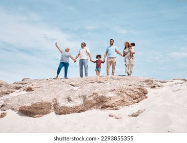 Its a perfect day at the beach. Shot of a multi-generational family spending the day at the beach. - Powered by Shutterstock