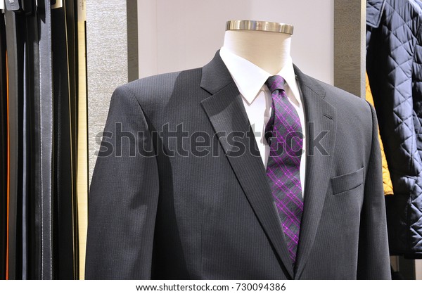 silver suit with purple tie