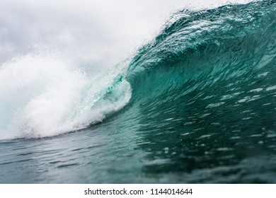 perfect empty blue waves on an overcast day with clouds.  Waves of Ireland, Scotland, Fiji, Hawaii, Fiji.   Waves of energy moves through the liguid Atlantic Ocean.