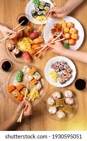 Perfect Family Diner With A Rich And Varied Selection Of Sushi. Various Salmon, Crab, Vegan Rolls, Wasabi, Ginger On Wooden Background. Japanese Cuisine.