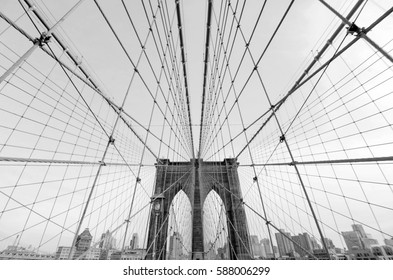 Perfect geometry of the Brooklyn Bridge cable web with overlook on Manhattan black and white monochrome modern but retro looking photo
