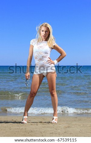 Similar – Young, long-legged, slim woman on the beach