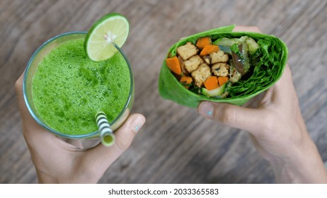 Perfect healthy quick and easy to make lunch of healthy delicious vegan lunch of vegan wrap and green juice. High angle