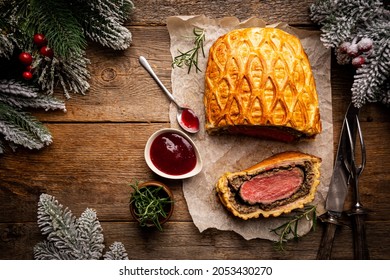 Perfect homemade juicy Beef Wellington, tenderloin dish on rustic wooden table, top view - Powered by Shutterstock