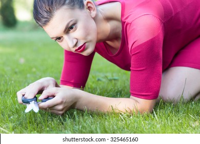 Perfect Housewife Is Cutting Grass With Scissors