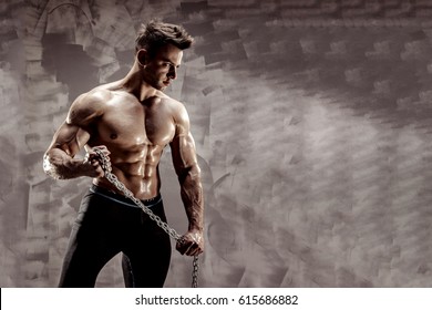 The Perfect male body - Awesome bodybuilder posing. Hold a chain - Powered by Shutterstock