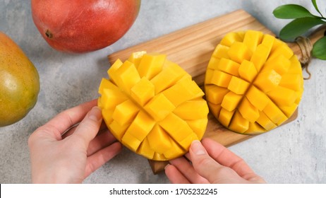 Perfect mango slice cut in cubes. Female hands holding fresh juicy mango. How to cut mango tutorial - Powered by Shutterstock