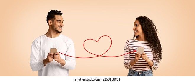 Perfect Match. Smiling Arab Man And Woman Holding Smartphones Connected With Drawn Red Heart Shape String, Romantic Middle Eastern Couple Using Modern Dating App, Creative Collage, Panorama - Shutterstock ID 2253158921