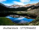 Perfect mirrored Image at Williams lake , Hiking in the Wheeler Wilderness nature area outdoor trails and empty vast Forests and gorgeous Lake above Taos New Mexico